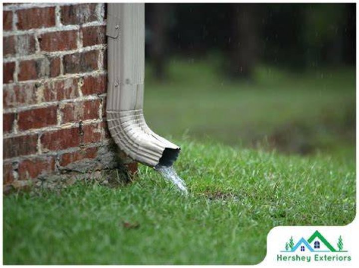 Where should gutter downspouts be placed?